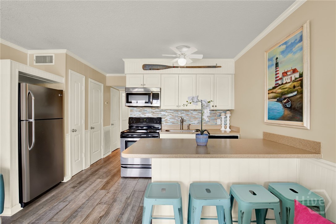 1217 Bay Street, Unit 105B Tybee Island, GA 31328 - Photo 8 of 46 Full Sized Kitchen with Stainless Steel Appliances