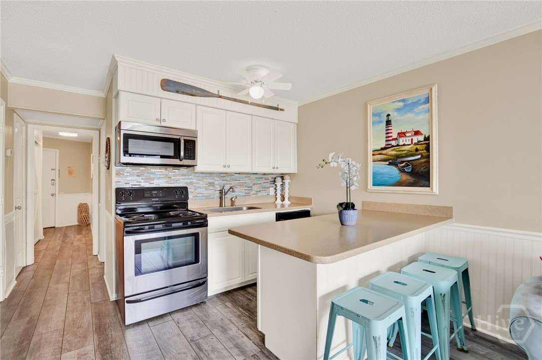 1217 Bay Street, Unit 105B Tybee Island, GA 31328 - Photo 9 of 46 Full Sized Kitchen with Stainless Steel Appliances