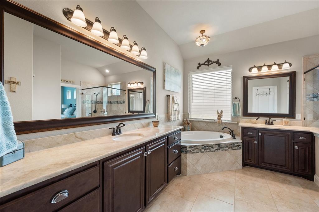 445 Rusty Run Drive Midlothian, TX 76065 - Photo 27 of 40 a large bathroom with a sink large mirror and bathtub