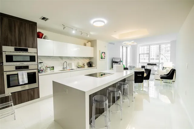 a large kitchen with a large counter top appliances and cabinets