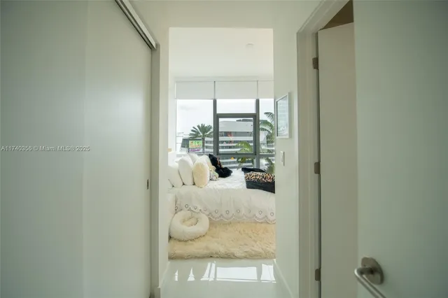 a room with a bed and glass door