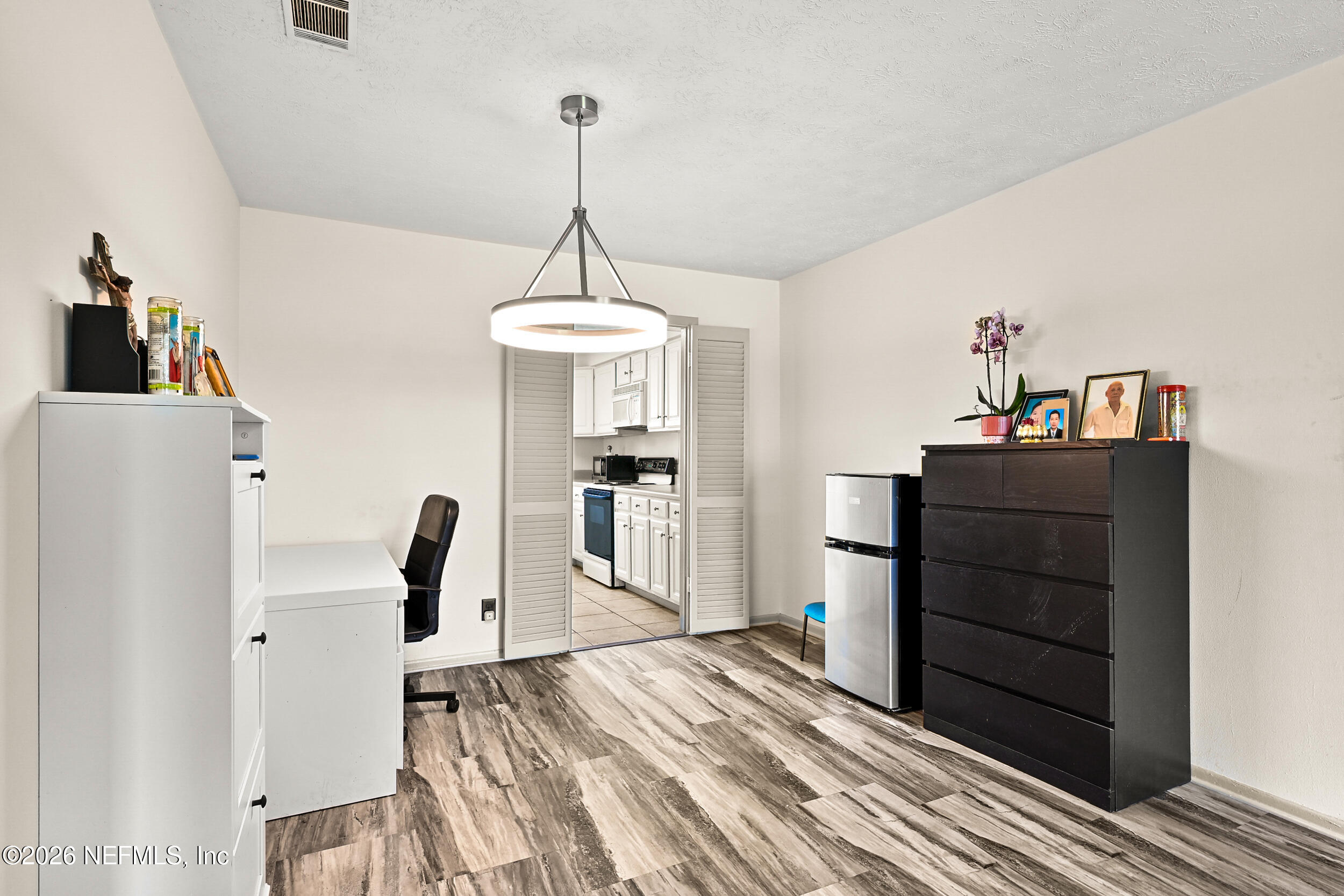 4915 Baymeadows Road, Unit 6G Jacksonville, FL 32217 - Photo 11 of 44 a bed room with a bed and a dresser