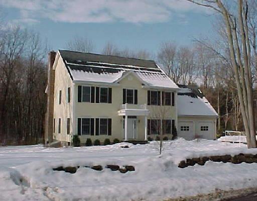 6 Canterbury Lane Wilton, CT 06897 - Photo 1 of 1 a front view of a house with a yard