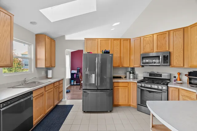 a kitchen with stainless steel appliances granite countertop a refrigerator and a sink