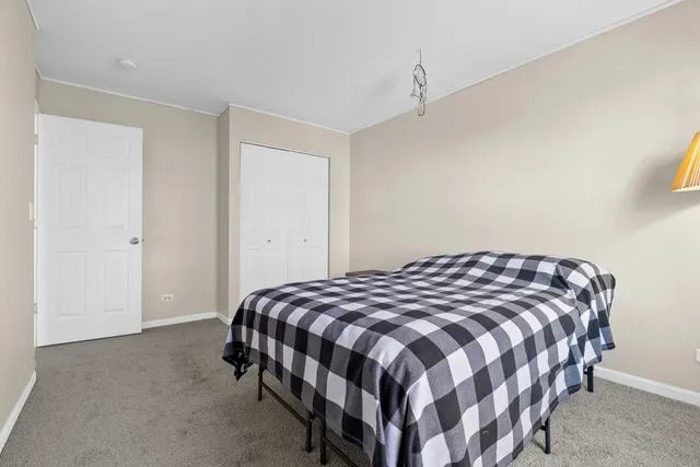 a bedroom with a bed lamp and a window