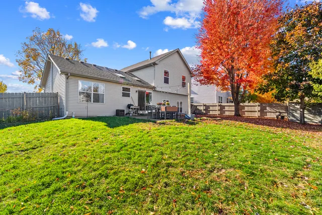 a front view of a house with a yard table and chairs