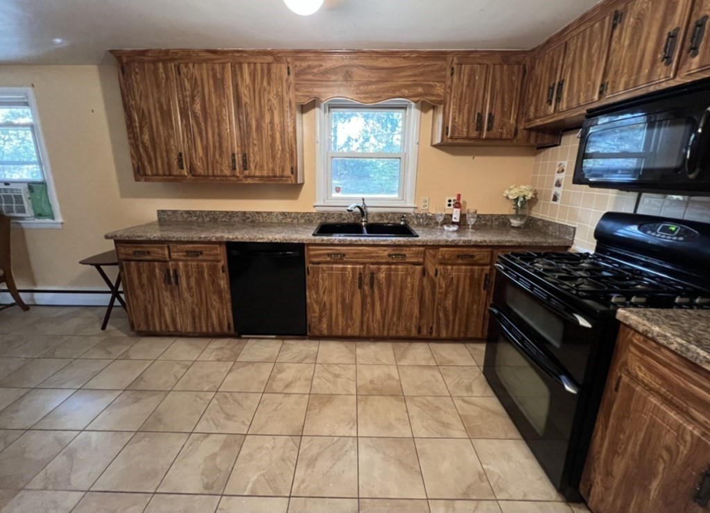 142 Blanche Street Springfield, MA 01119 - Photo 3 of 27 a kitchen with a stove top oven sink and cabinets