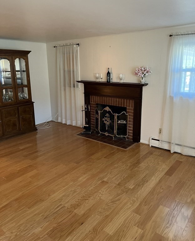 142 Blanche Street Springfield, MA 01119 - Photo 7 of 27 a view of an empty room with wooden floor and a fireplace