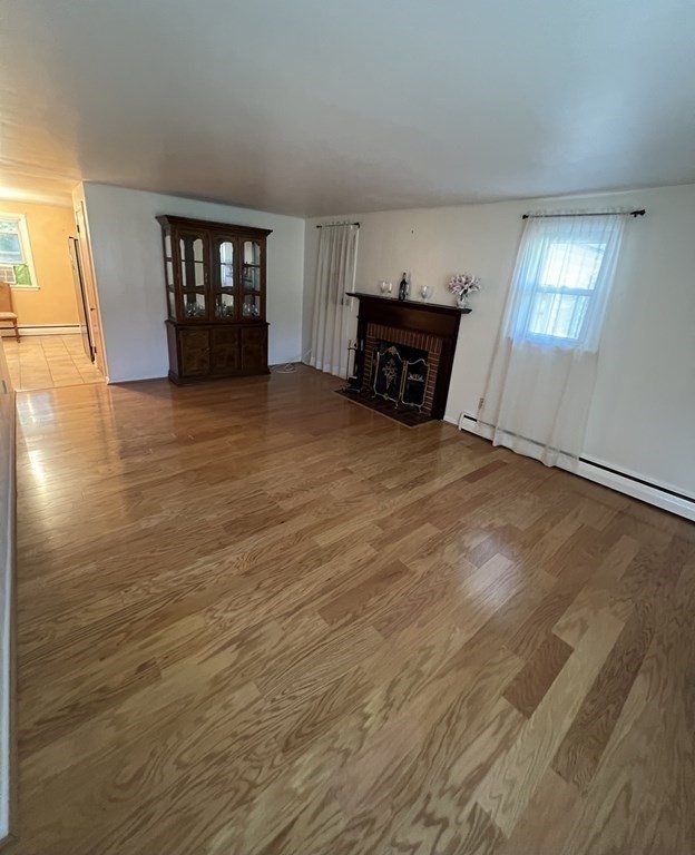 142 Blanche Street Springfield, MA 01119 - Photo 8 of 27 a big room with wooden floor fireplace and windows