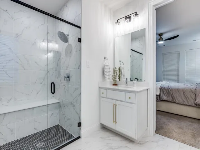 a bathroom with a double vanity sink mirror and shower