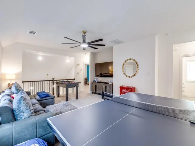 a living room with furniture a window and a flat screen tv