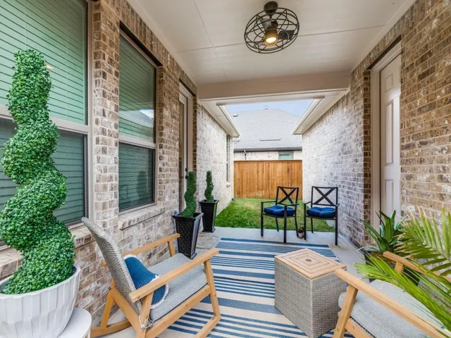 a view of house with patio outdoor seating and flowers