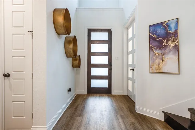 a view of a hallway with wooden floor and closet