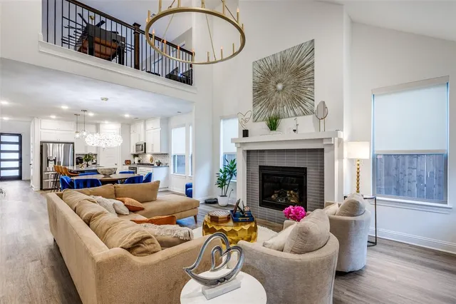 a living room with furniture a fireplace and a potted plant