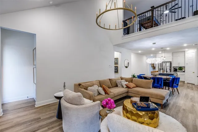 a living room with furniture and kitchen view