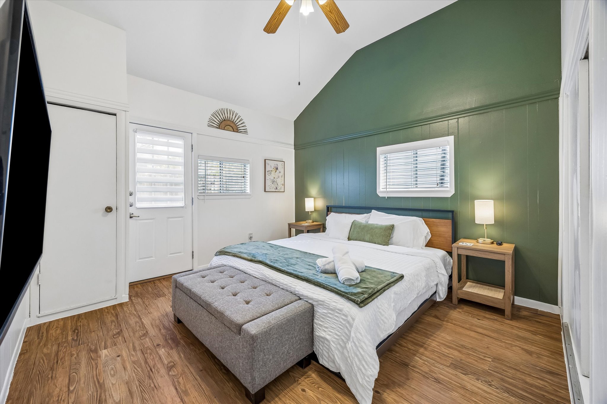 211 Lessin Lane, Unit B Austin, TX 78704 - Photo 9 of 16 This room features wood-look flooring, a vaulted ceiling, and a ceiling fan