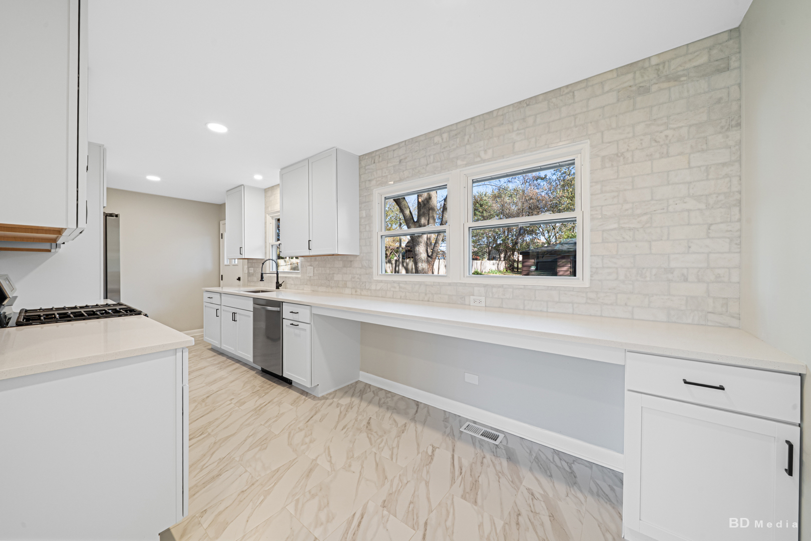 6205 Belmont Road Downers Grove, IL 60516 - Photo 11 of 30 a kitchen with a stove a sink and a refrigerator