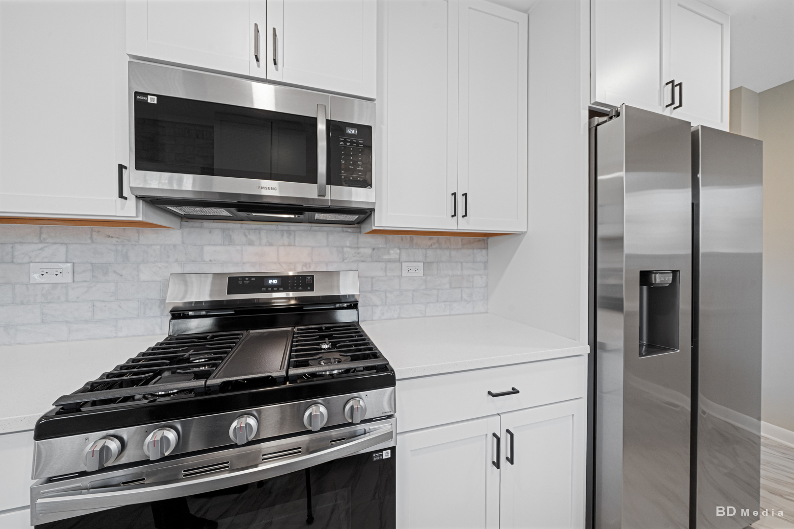 6205 Belmont Road Downers Grove, IL 60516 - Photo 12 of 30 a kitchen with stainless steel appliances a refrigerator stove and microwave