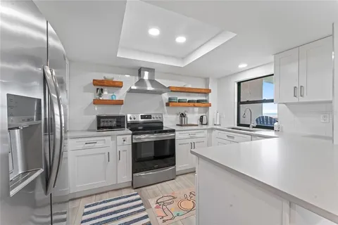 a kitchen with stainless steel appliances a sink stove and refrigerator