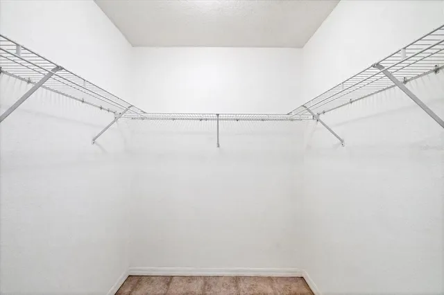 a bathroom with a granite countertop sink a mirror and a bathtub
