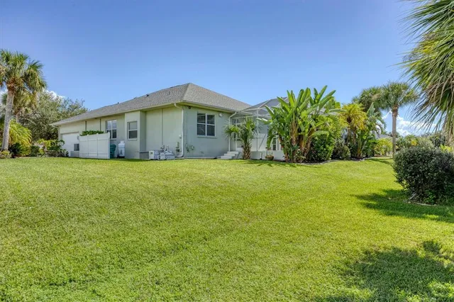 a view of house with a yard