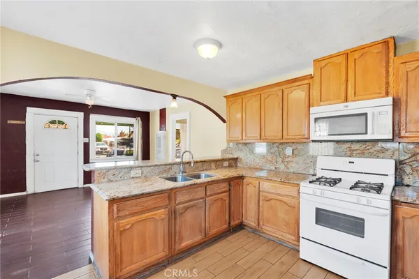 a kitchen with a sink stove and cabinets