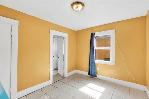 a view of a livingroom with wooden floor and a window