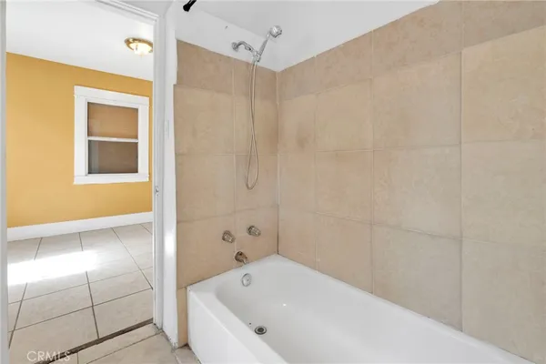 a bathroom with a bathtub and shower