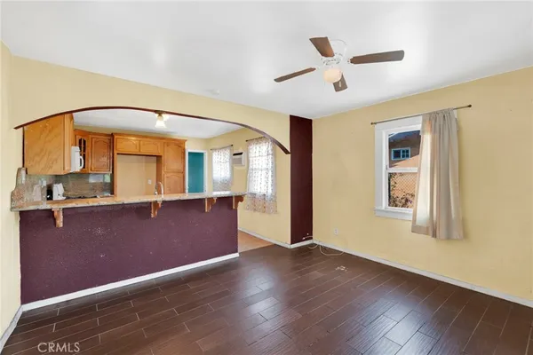 a big room with wooden floor and windows