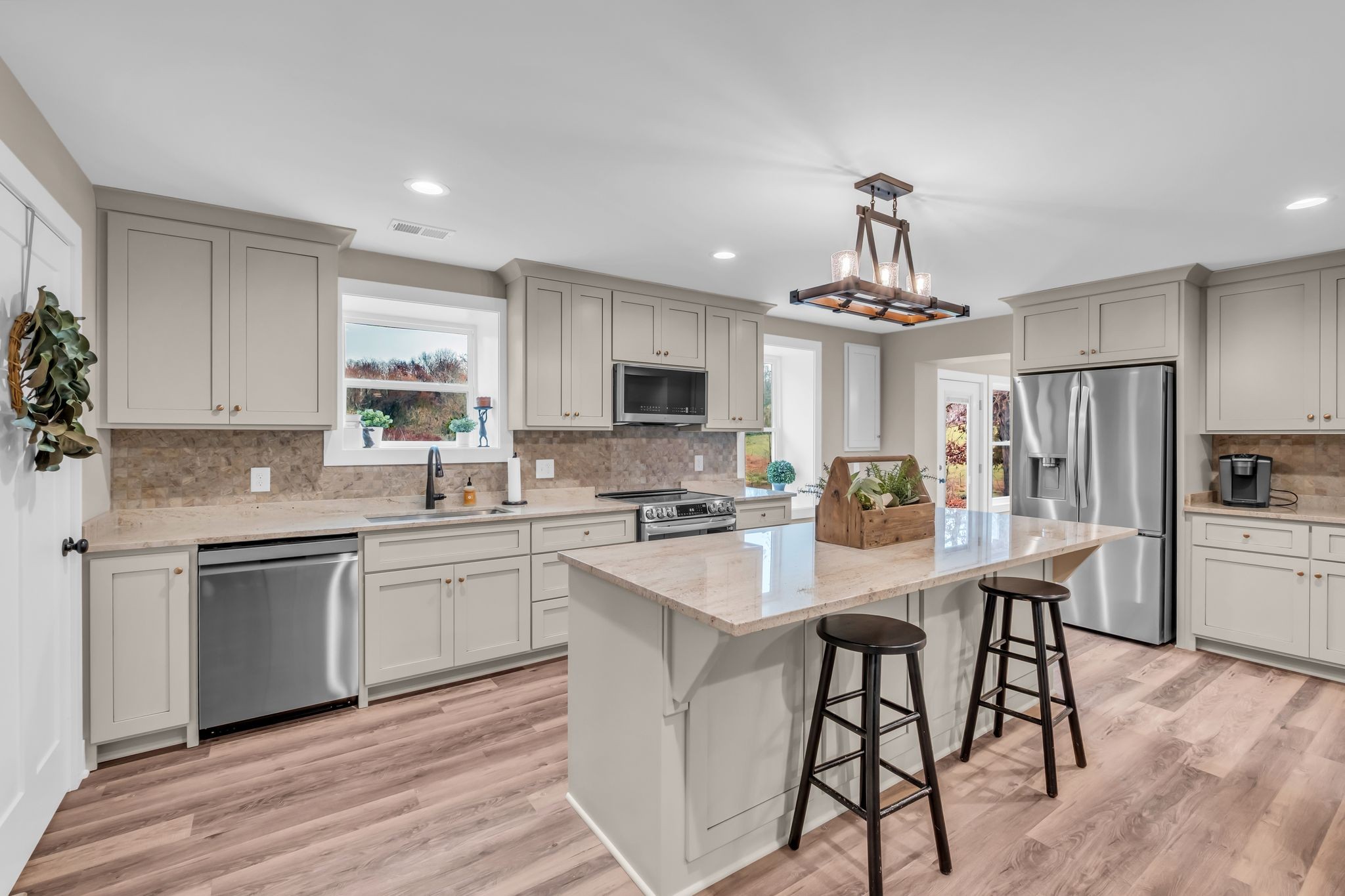 372 Lee Road Cottontown, TN 37048 - Photo 16 of 52 a kitchen with stainless steel appliances a white table chairs and a stove