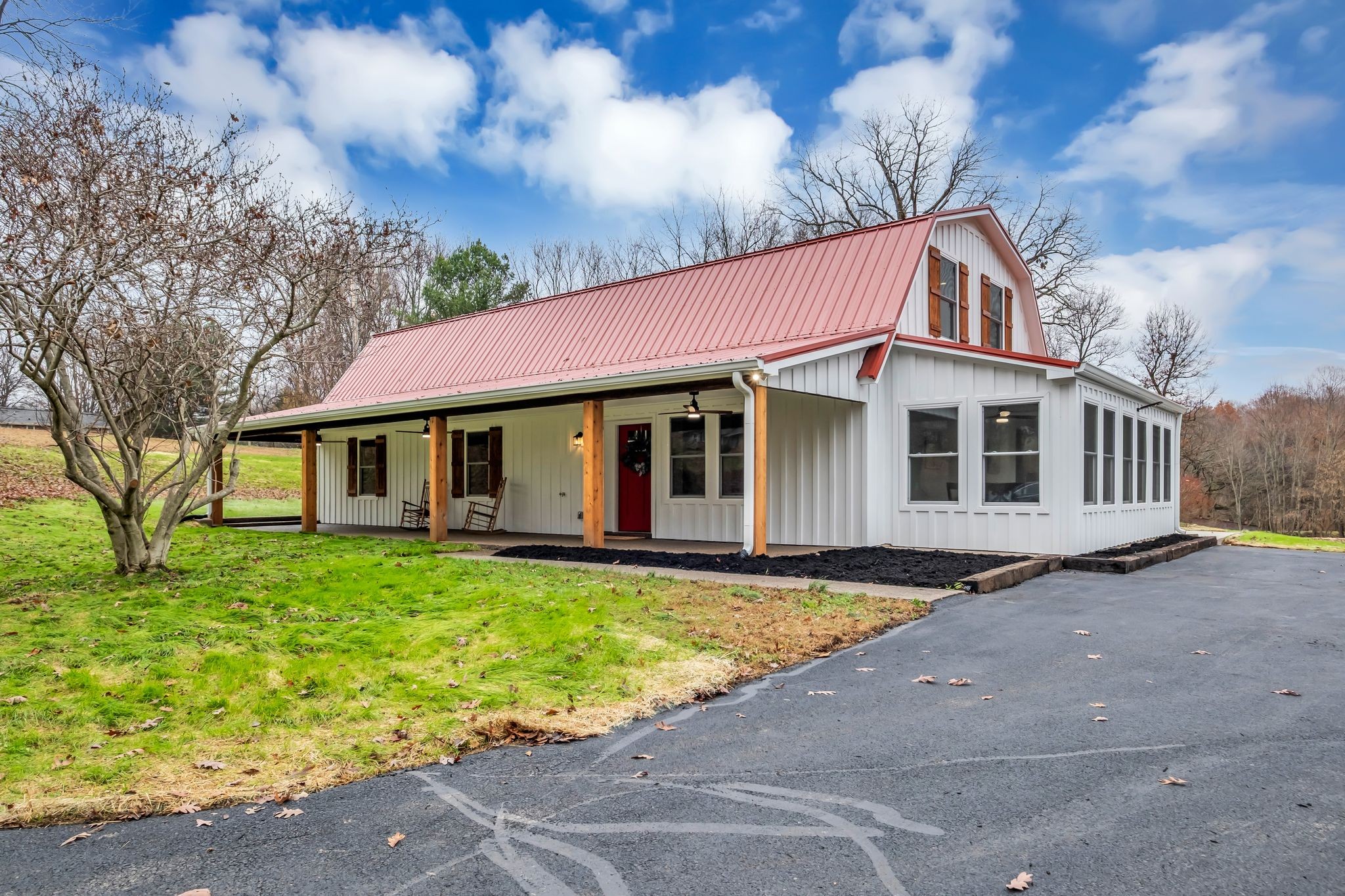 372 Lee Road Cottontown, TN 37048 - Photo 8 of 52 a view of a white house with a large windows and a yard
