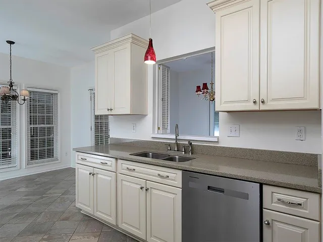 a kitchen with stainless steel appliances granite countertop a sink and cabinets