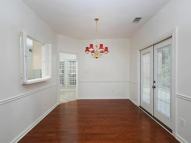 a view of a livingroom with wooden floor and entryway