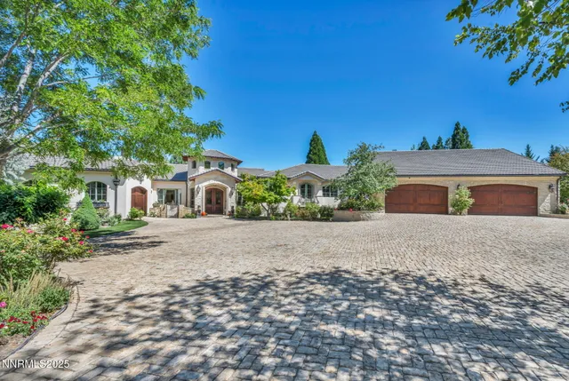 a dining room with furniture and a floor to ceiling window