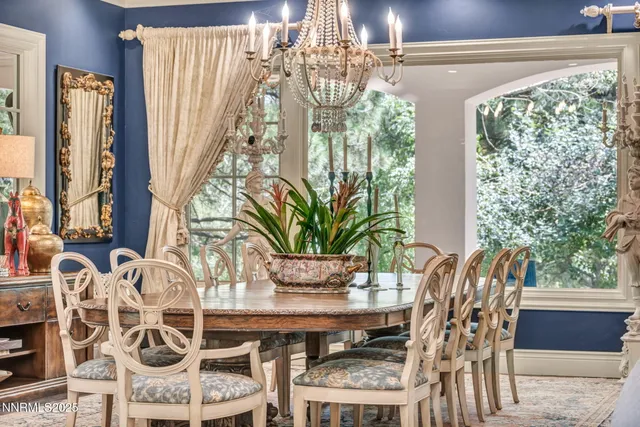a living room with fireplace furniture and a painting on the wall