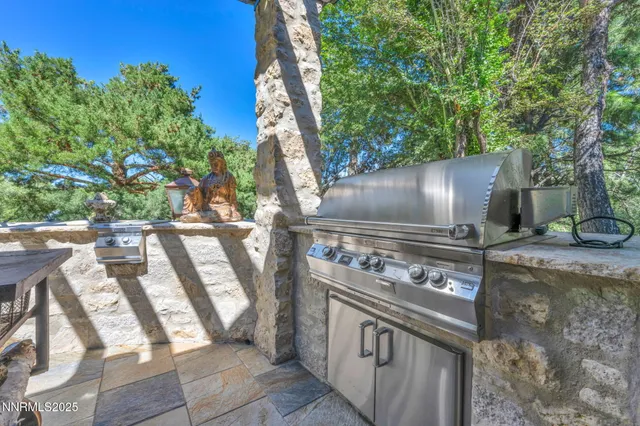 a living room with a large window and a chandelier