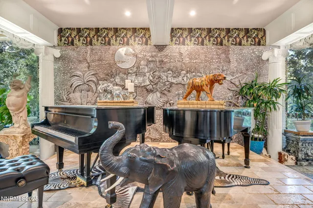 a living room with furniture a fireplace and a large window