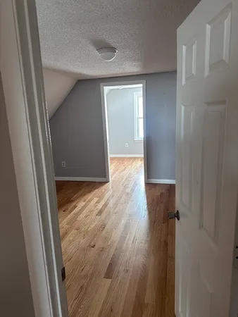 a view of hallway with wooden floor
