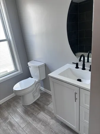 a bathroom with a toilet sink and mirror