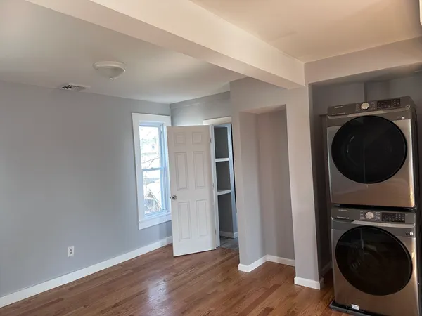 a view of a hallway with washer and dryer