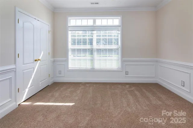 a view of a small space with wooden floor and a window