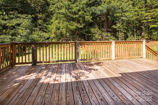 a view of a backyard with a table and chairs under an umbrella