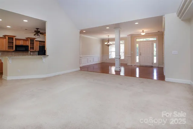 a large white kitchen with a large window