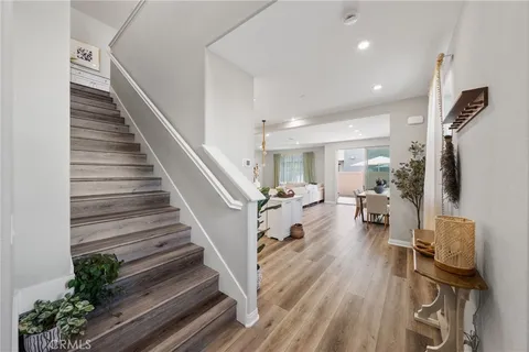 a view of entryway and hall with wooden floor