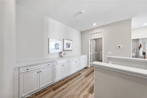 a large white room with mirror and a sink