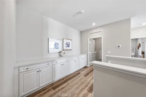 a large white room with mirror and a sink