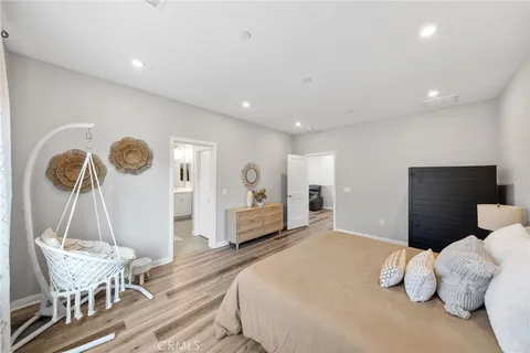a spacious bedroom with a bed and a window