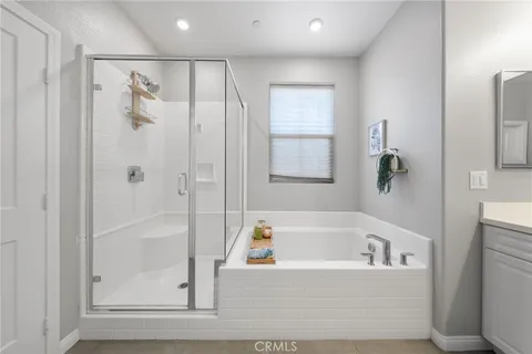a white bath tub sitting next to a shower