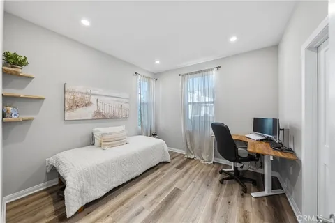 a bedroom with a bed and a desk