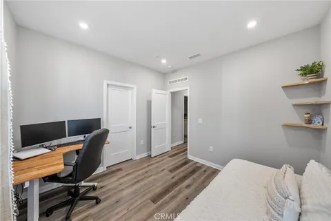 a bedroom with a bed and a desk